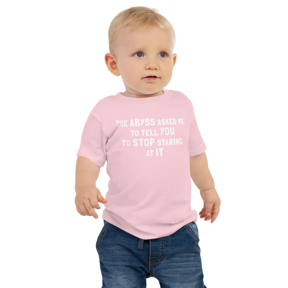 "The Abyss asked me to tell you to stop staring at it" printed on a pink baby jersey short sleeve tee worn by a male