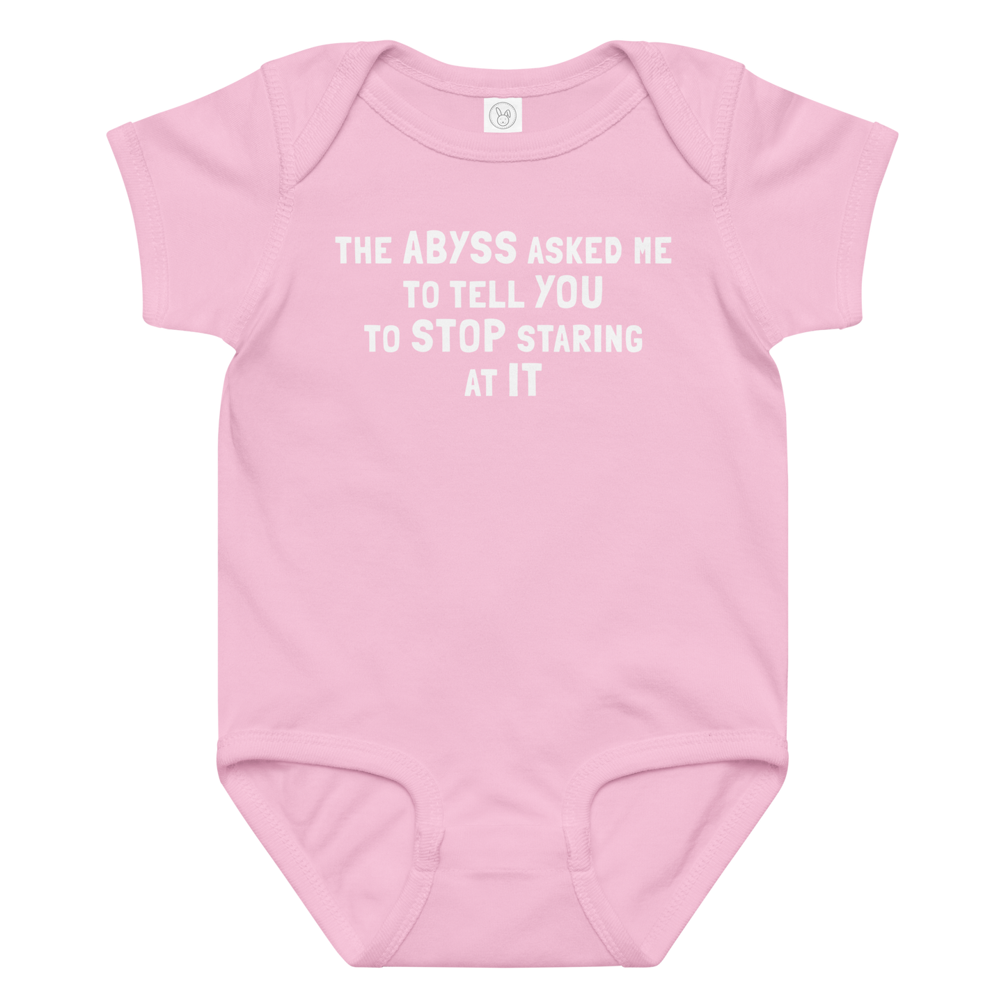 "The Abyss asked me to tell you to stop staring at it" printed on a pink baby jersey bodysuit laying on a flat surface amongst other clothes