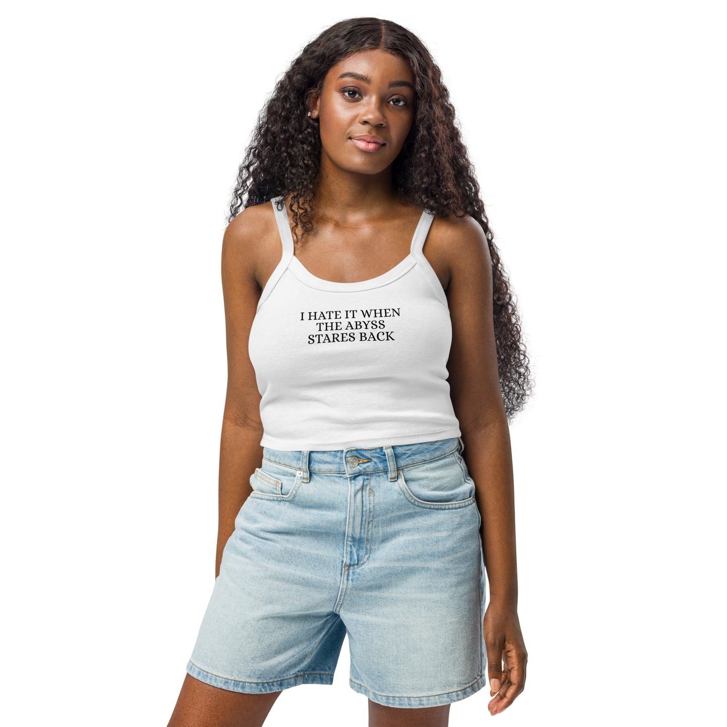 "I hate it when the abyss stares back" printed on a solid white blend women's micro-rib tanktop worn by a female
