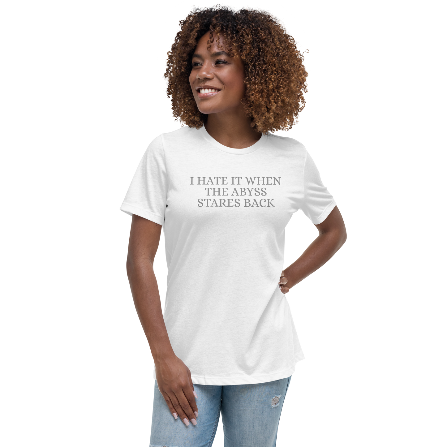 "I hate it when the abyss stares back" printed on a white women's relaxed t-shirt worn by a female