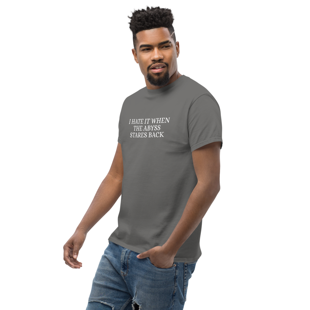 "I hate it when the abyss stares back" printed on a charcoal unisex classic tee worn by a male