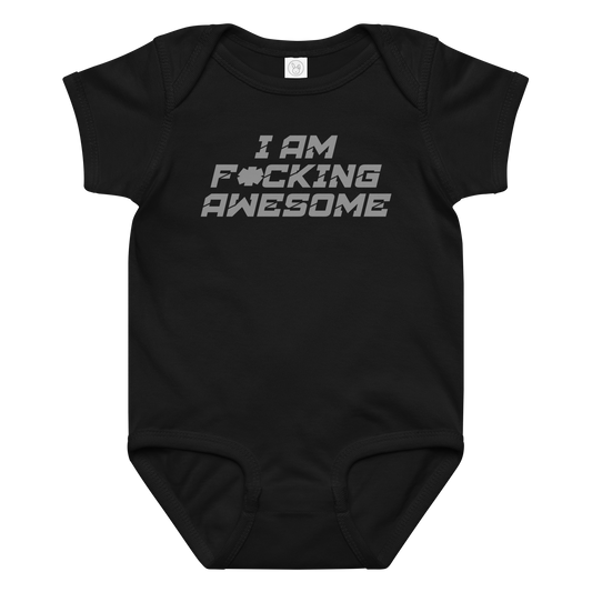 "I Am F*cking Awesome" printed on a black baby jersey bodysuit laying on a flat surface amongst other clothes