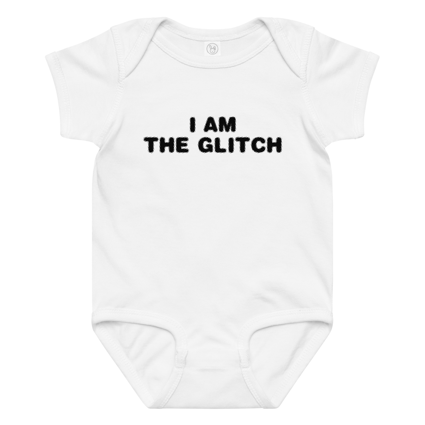 "I am the glitch" printed on a white baby jersey bodysuit laying on a flat surface amongst other clothes