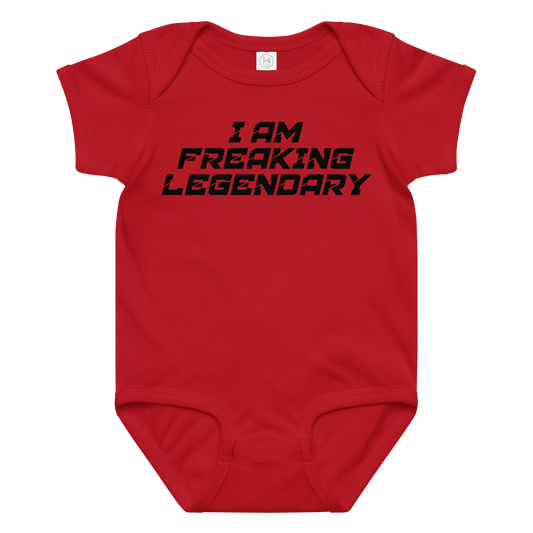 "I Am Freaking Legendary" printed on a red baby jersey bodysuit laying on a flat surface amongst other clothes