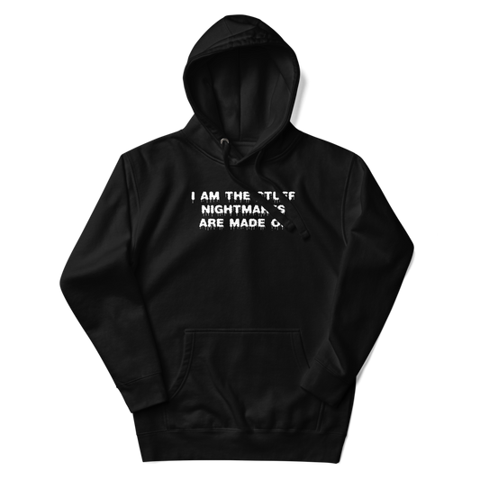 "I am the stuff nightmares are made of" printed on a black unisex hoodie laying on a flat surface with the hood up