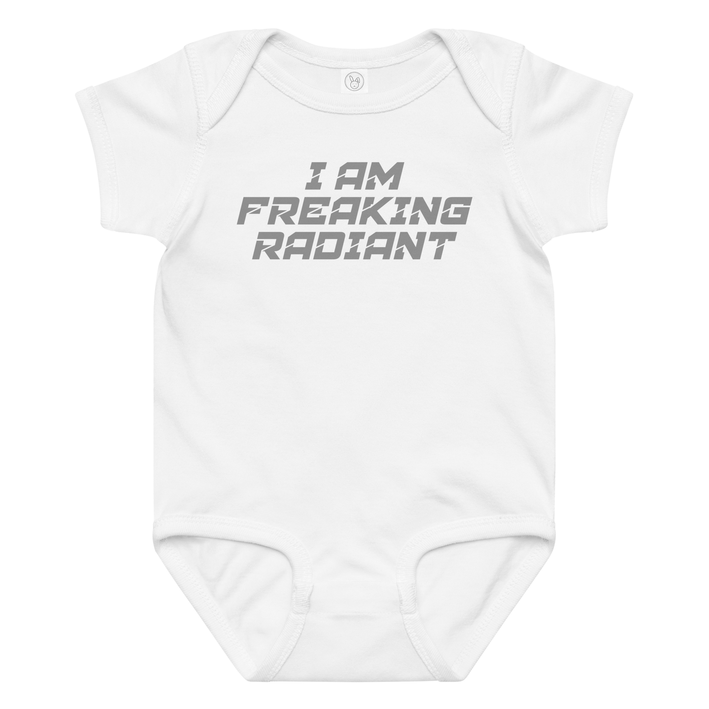 "I Am Freaking Radiant" printed on a white baby jersey bodysuit laying on a flat surface amongst other clothes