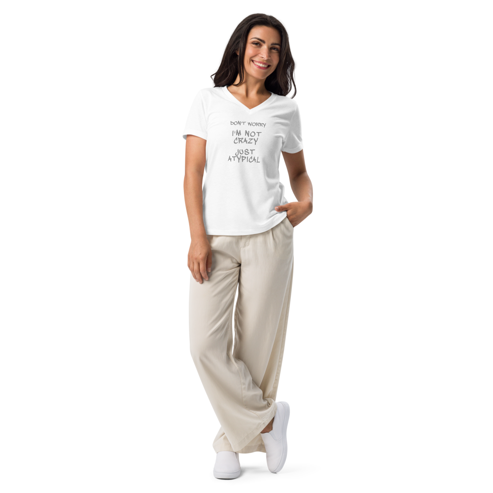 "Don't Worry I'm Not Crazy Just Atypical" printed on a solid white blend women's relaxed v-neck t-shirt worn by a female
