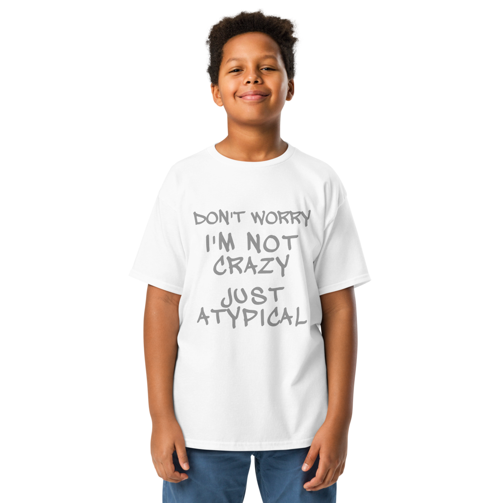 "Don't Worry I'm Not Crazy Just Atypical" printed on a white youth classic tee worn by a male