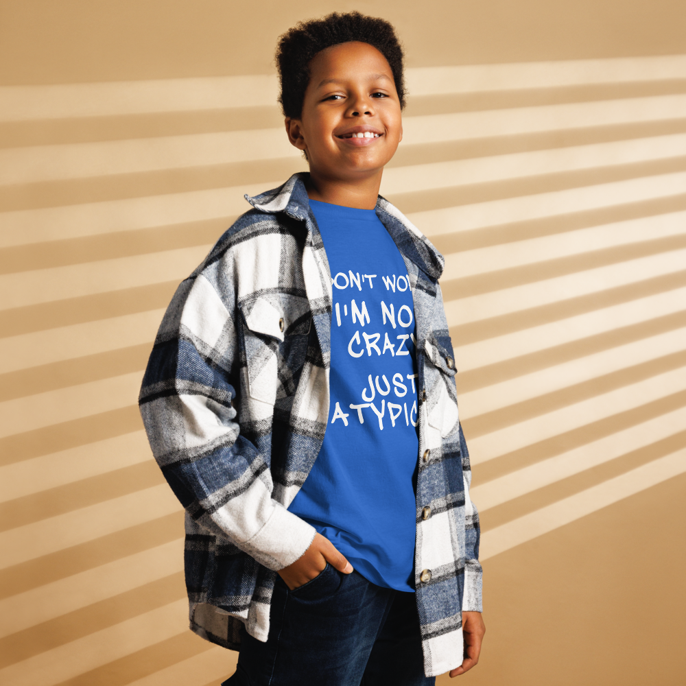 "Don't Worry I'm Not Crazy Just Atypical" printed on a royal youth classic tee worn by a male also wearing a jacket
