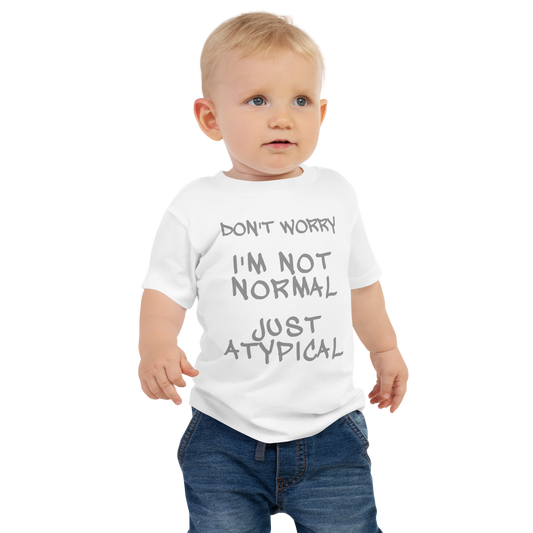 "Don't Worry I'm Not Normal Just Atypical" printed on a white baby jersey short sleeve tee worn by a male