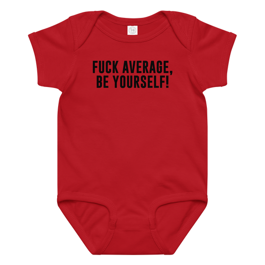 "Fuck Average, Be Yourself!" printed on a red baby jersey bodysuit laying on a flat surface amongst other clothes