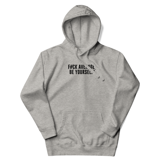 "F#Ck Average, Be Yourself!" printed on a carbon grey unisex hoodie laying on a flat surface with the hood up