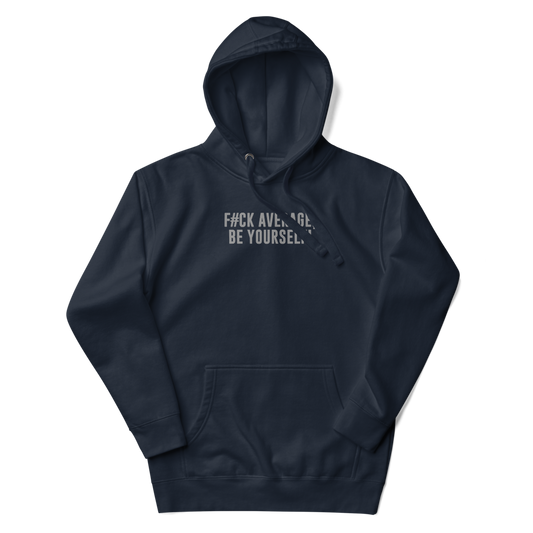 "F#Ck Average, Be Yourself!" printed on a navy blazer unisex hoodie laying on a flat surface with the hood up