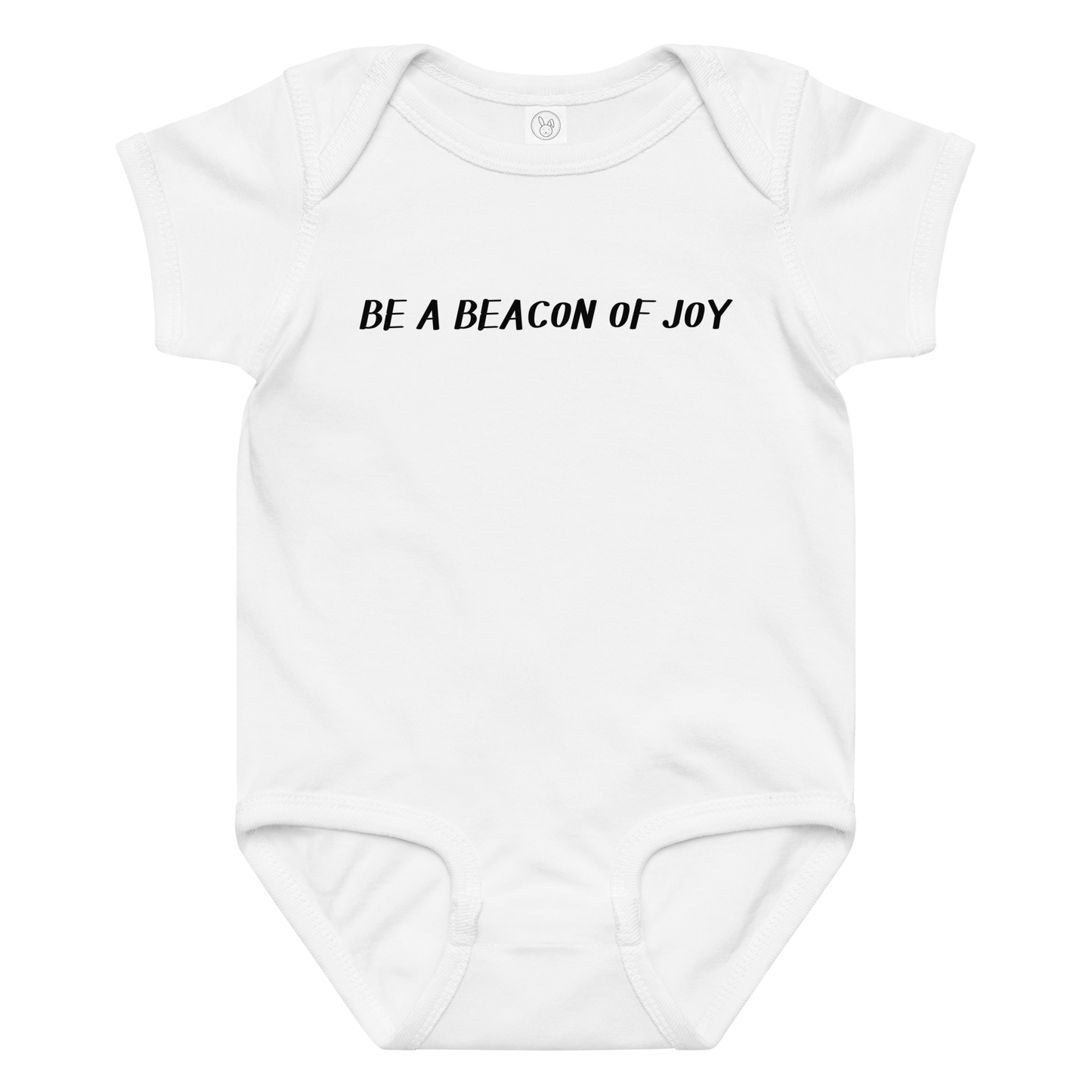 "Be a beacon of joy" printed on a white baby jersey bodysuit laying on a flat surface amongst other clothes