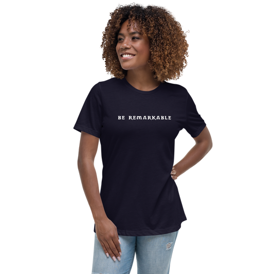 "Be remarkable" printed on a navy women's relaxed t-shirt worn by a female