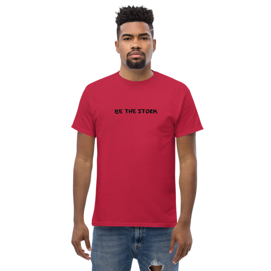 "Be the storm" printed on a cardinal unisex classic tee worn by a male