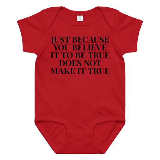 "Just because you believe it to be true does not make it true" printed on a red baby jersey bodysuit laying on a flat surface amongst other clothes