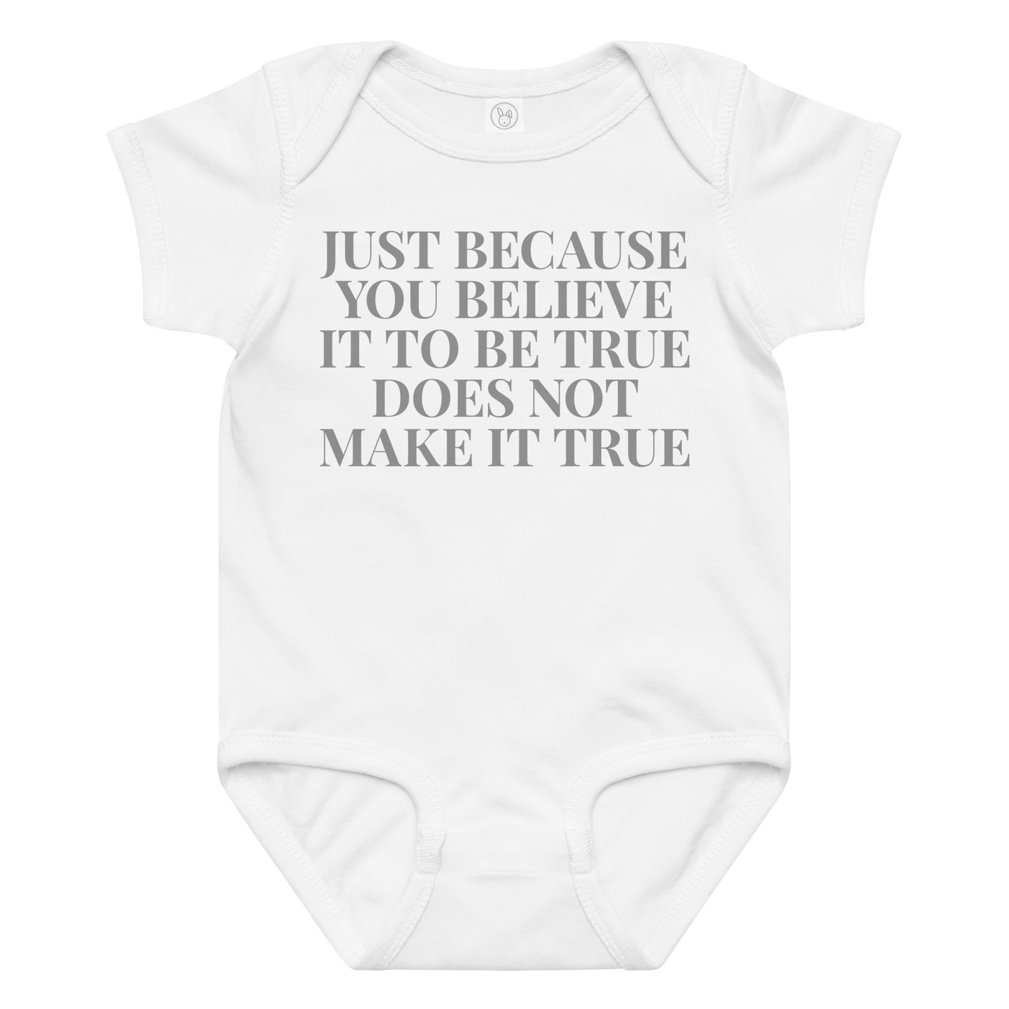 "Just because you believe it to be true does not make it true" printed on a white baby jersey bodysuit laying on a flat surface amongst other clothes