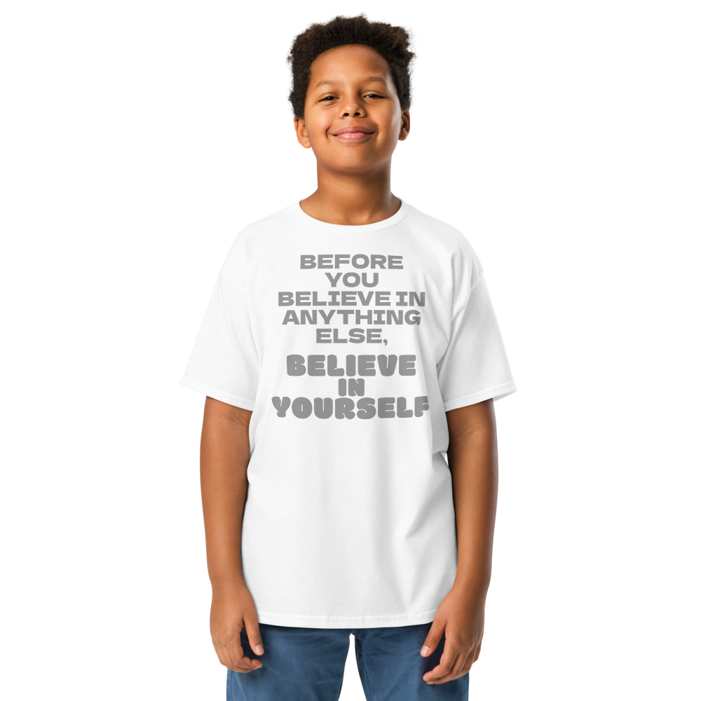 "Before you believe in anything else, believe in yourself" printed on a white youth classic tee worn by a male