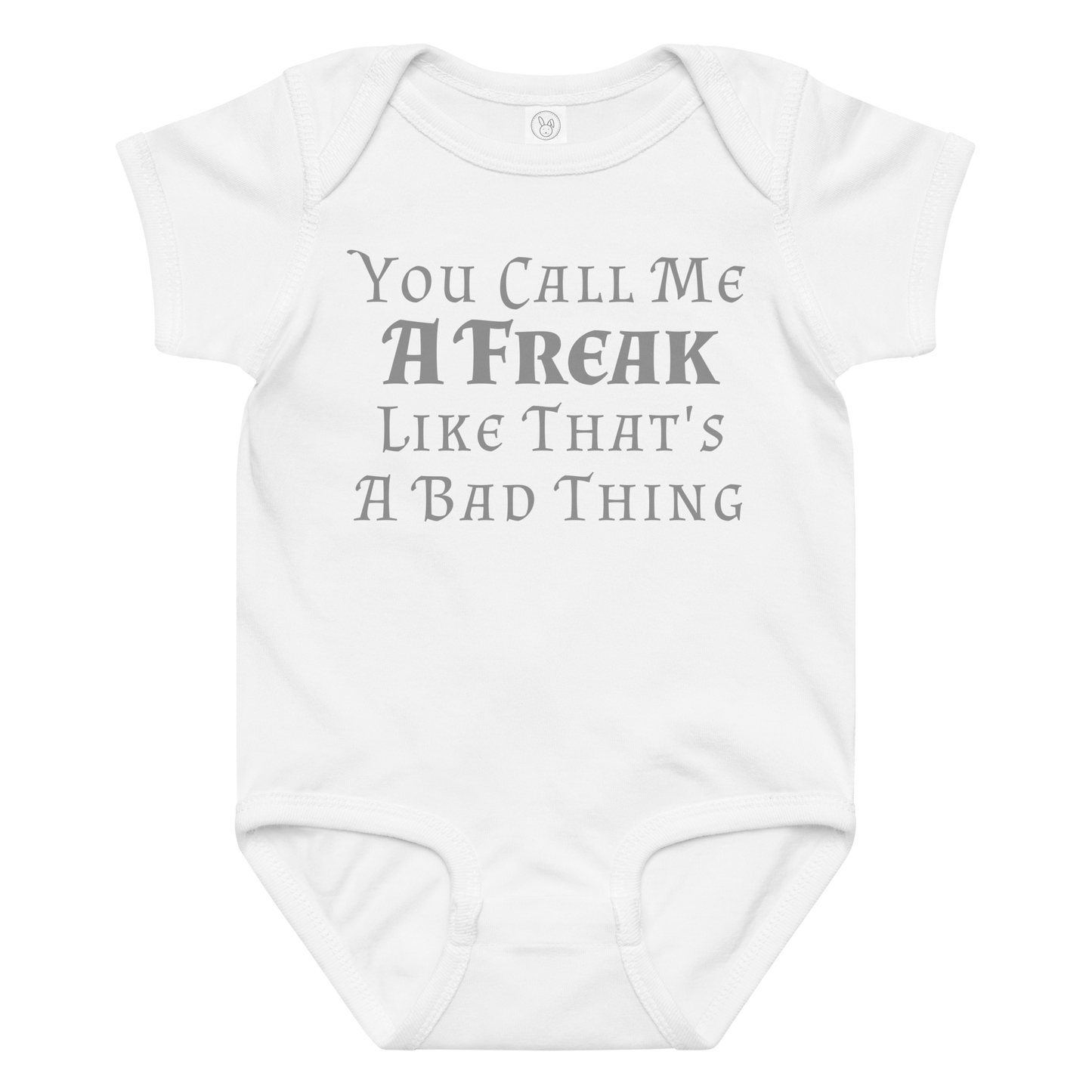 "You Call Me A Freak Like That's A Bad Thing" printed on a white baby jersey bodysuit laying on a flat surface amongst other clothes