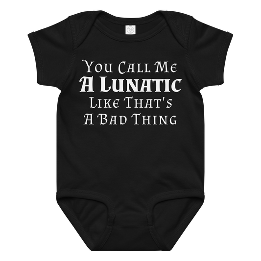 "You Call Me A Lunatic Like That's A Bad Thing" printed on a black baby jersey bodysuit laying on a flat surface amongst other clothes