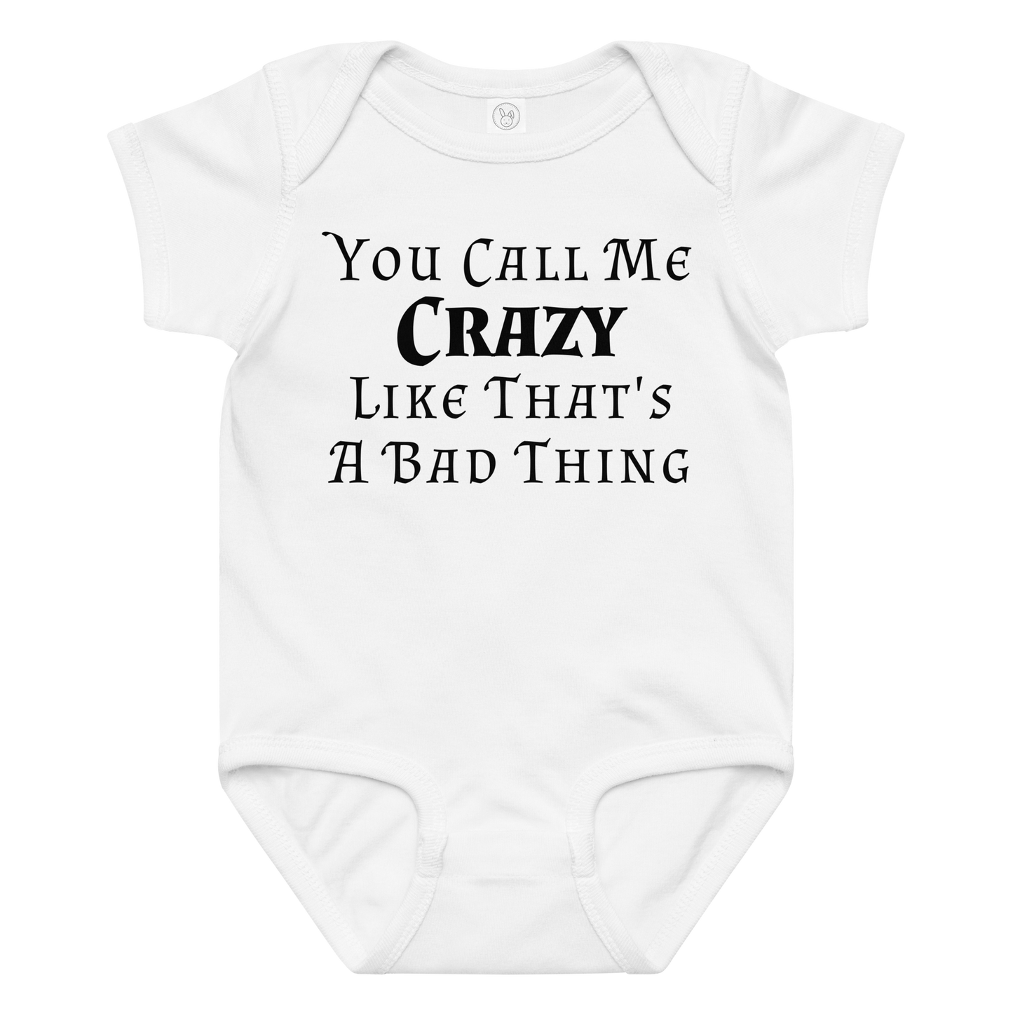 "You Call Me Crazy Like That's A Bad Thing" printed on a white baby jersey bodysuit laying on a flat surface amongst other clothes