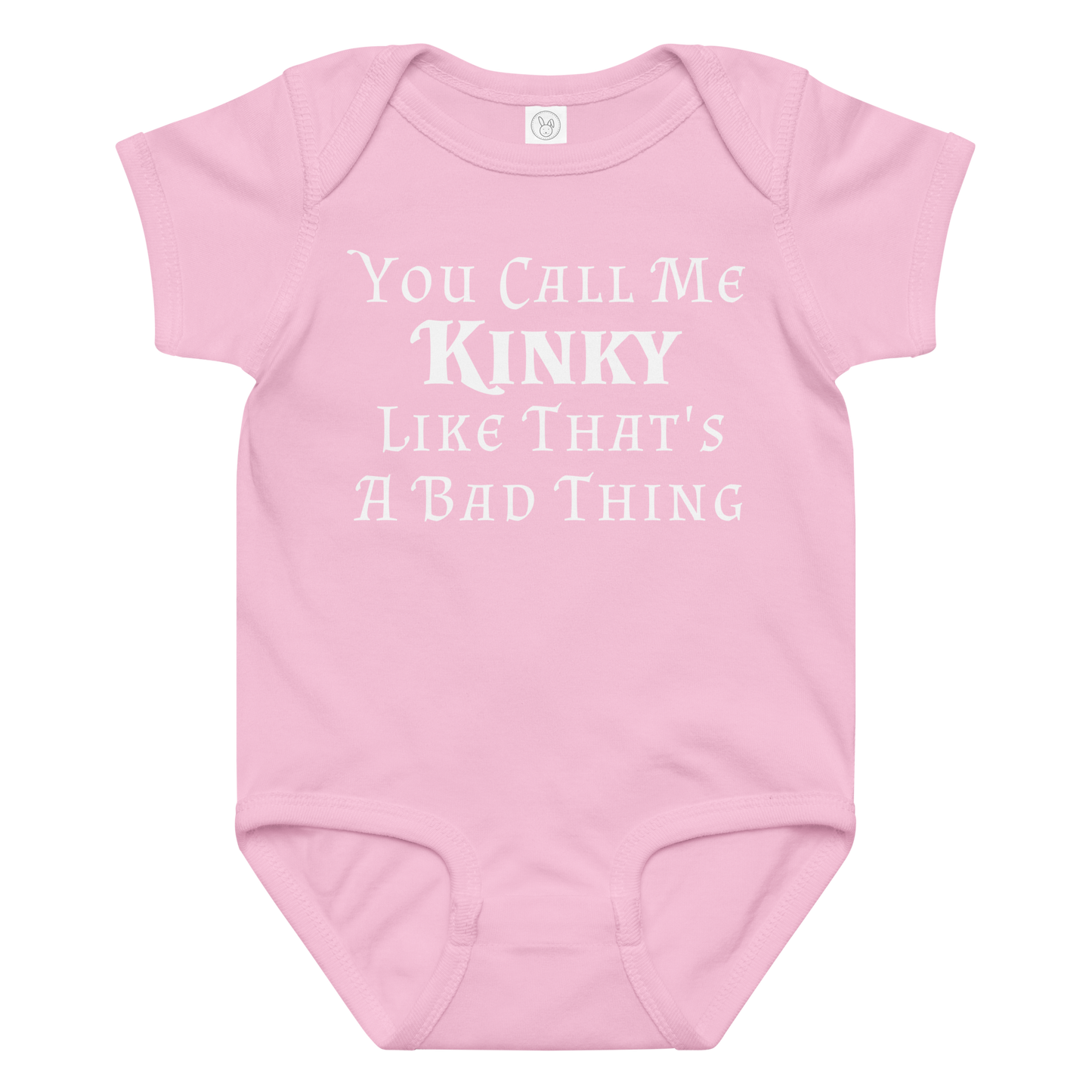 "You Call Me Kinky Like That's A Bad Thing" printed on a pink baby jersey bodysuit laying on a flat surface amongst other clothes