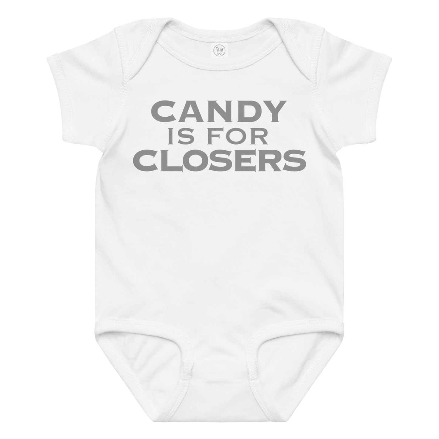 "Candy Is For Closers" printed on a white baby jersey bodysuit laying on a flat surface amongst other clothes