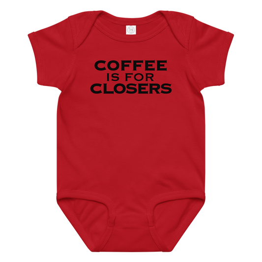 "Coffee Is For Closers" printed on a red baby jersey bodysuit laying on a flat surface amongst other clothes