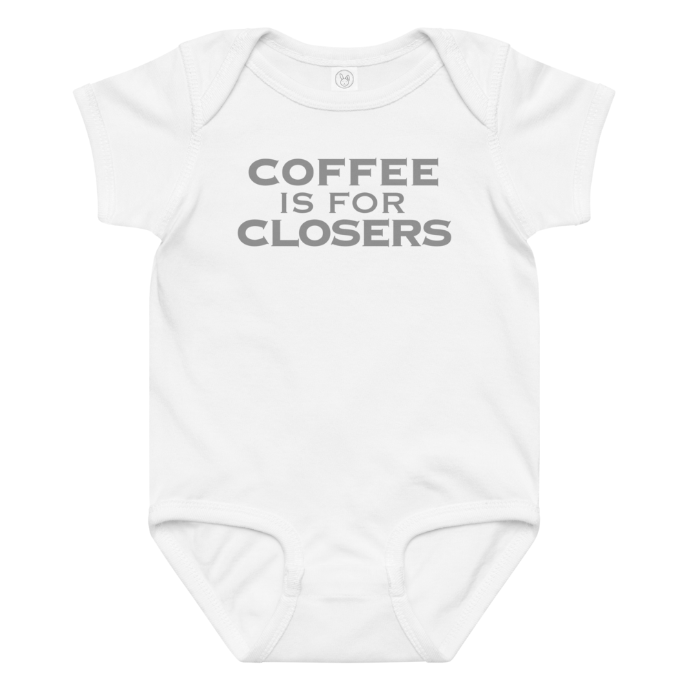 "Coffee Is For Closers" printed on a white baby jersey bodysuit laying on a flat surface amongst other clothes