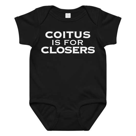 "Coitus Is For Closers" printed on a black baby jersey bodysuit laying on a flat surface amongst other clothes