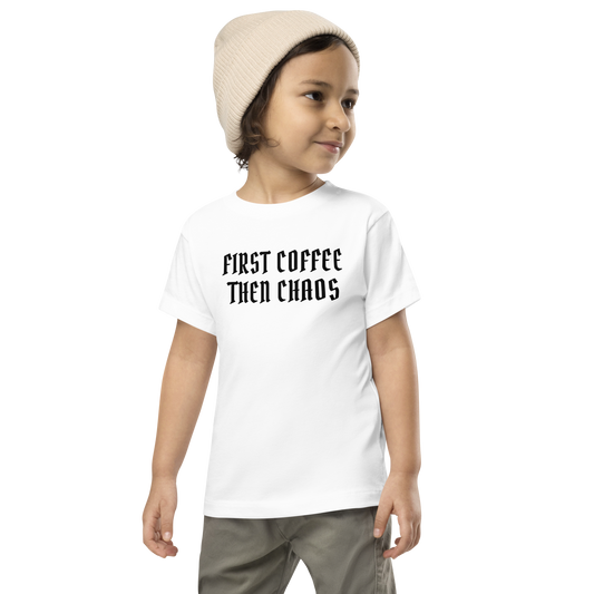 "First Coffee Then Chaos" printed on a white toddler short sleeve tee worn by a male wearing a cap