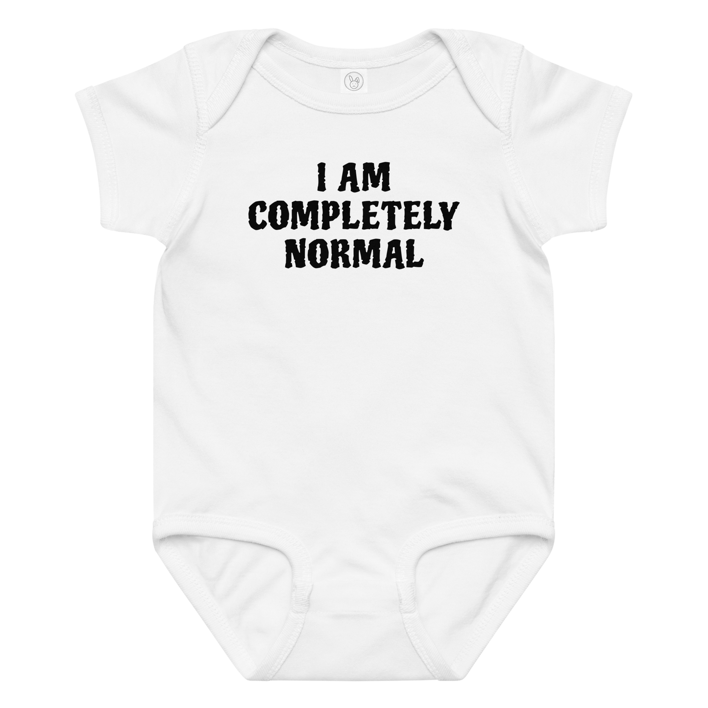 "I am completely normal" printed on a white baby jersey bodysuit laying on a flat surface amongst other clothes