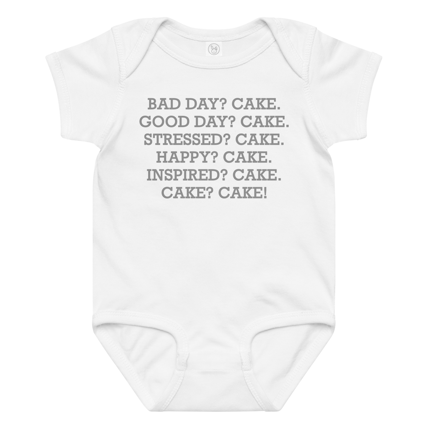 "Bad Day? Cake. Good Day? Cake. Stressed? Cake. Happy? Cake. Inspired? Cake. Cake? Cake!" printed on a white baby jersey bodysuit laying on a flat surface amongst other clothes