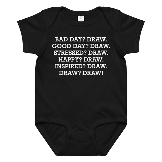 "Bad Day? Draw. Good Day? Draw. Stressed? Draw. Happy? Draw. Inspired? Draw. Draw? Draw!" printed on a black baby jersey bodysuit laying on a flat surface amongst other clothes