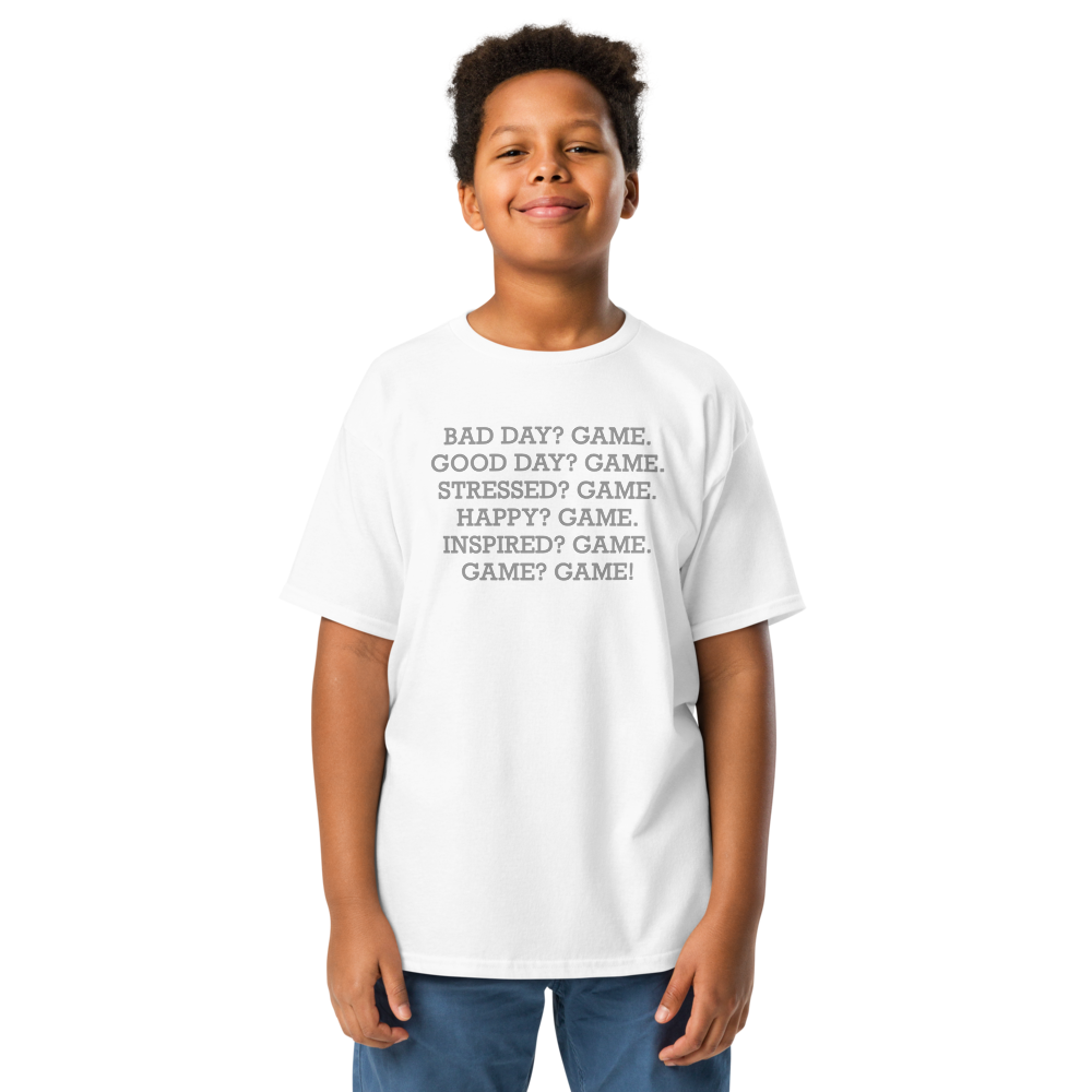 "Bad Day? Game. Good Day? Game. Stressed? Game. Happy? Game. Inspired? Game. Game? Game!" printed on a white youth classic tee worn by a male