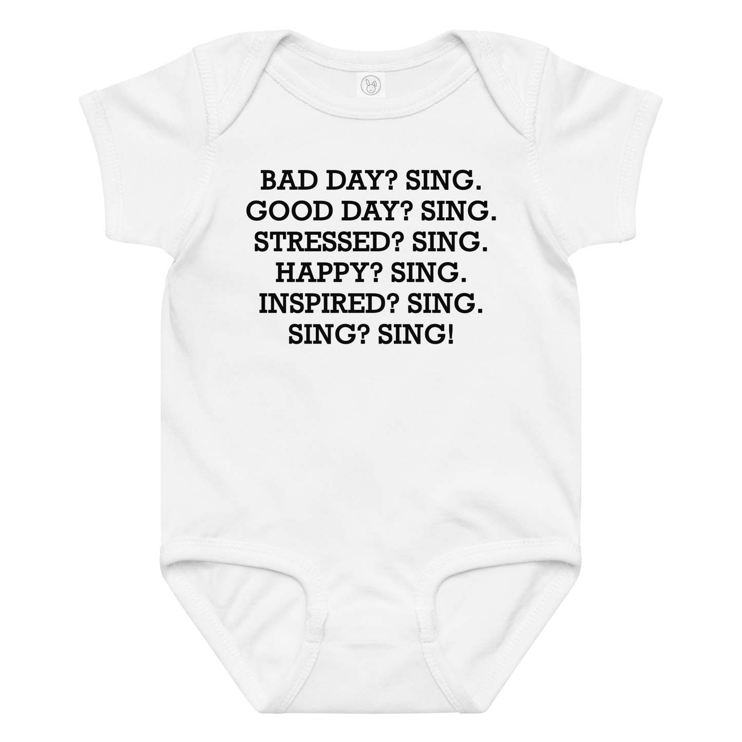 "Bad Day? Sing. Good Day? Sing. Stressed? Sing. Happy? Sing. Inspired? Sing. Sing? Sing!" printed on a white baby jersey bodysuit laying on a flat surface amongst other clothes