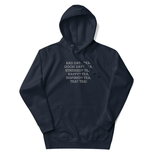 "Bad Day? Tea. Good Day? Tea. Stressed? Tea. Happy? Tea. Inspired? Tea. Tea? Tea!" printed on a navy blazer unisex hoodie laying on a flat surface with the hood up