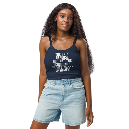 "The Only defense against the ignorance of men is the brilliance of women" printed on a solid navy blend women's micro-rib tanktop worn by a female
