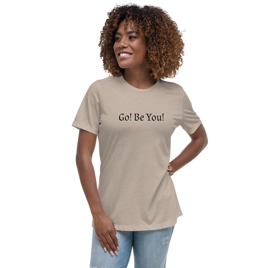 "Go! Be You!" printed on a heather stone women's relaxed t-shirt worn by a female