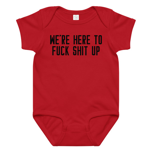 "We're Here To Fuck Shit Up" printed on a red baby jersey bodysuit laying on a flat surface amongst other clothes