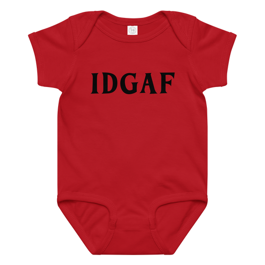 "IDGAF" printed on a red baby jersey bodysuit laying on a flat surface amongst other clothes