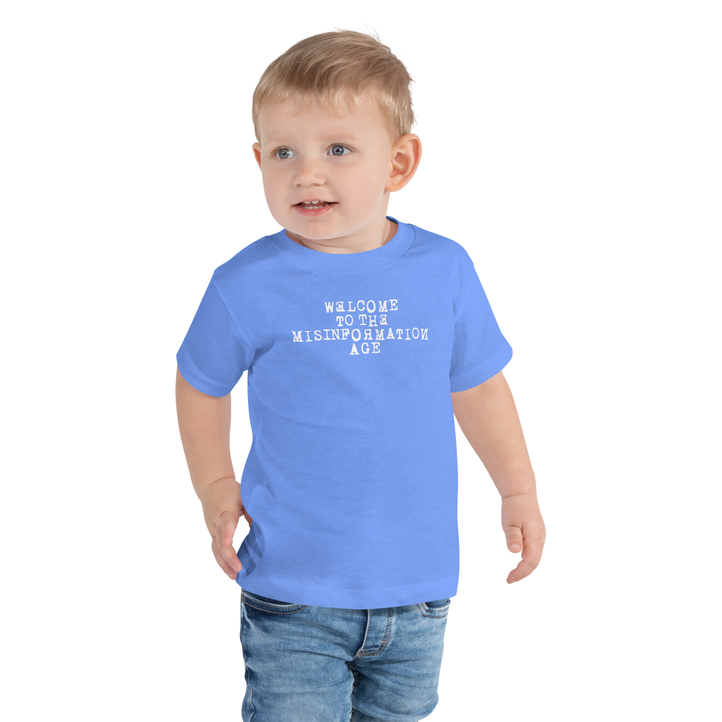 "Welcome to the misinformation age" printed on a heather columbia blue toddler short sleeve tee worn by a male