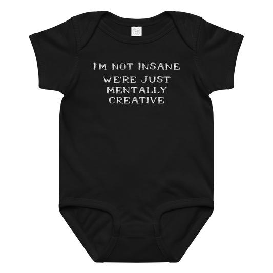 "I’m not insane We’re just mentally creative" printed on a black baby jersey bodysuit laying on a flat surface amongst other clothes