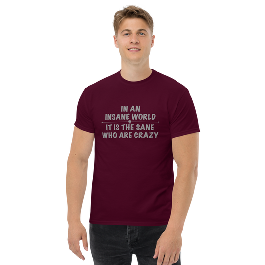 "In an insane world, it is the sane who are crazy" printed on a maroon unisex classic tee worn by a male