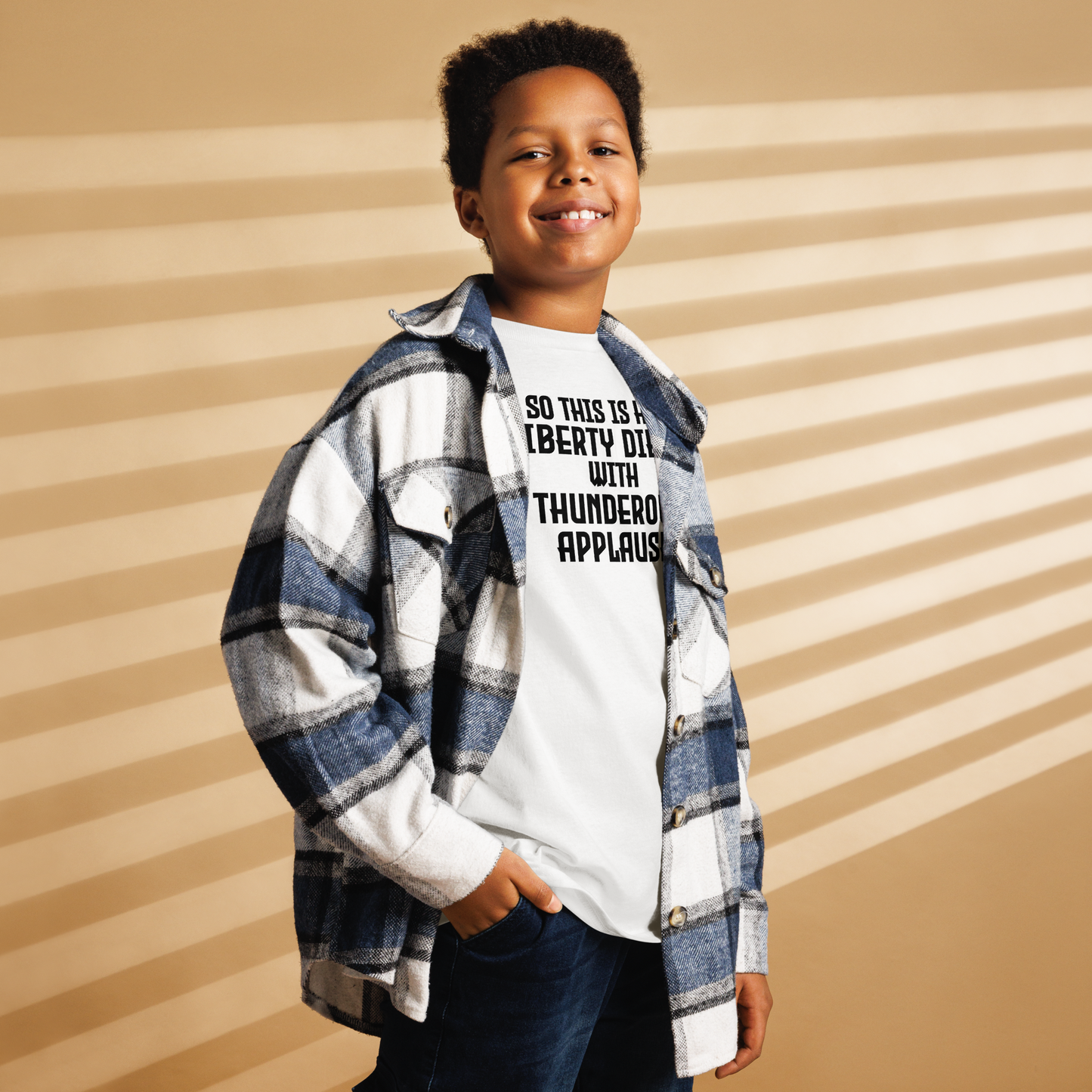 "So this is how liberty dies… with thunderous applause" printed on a white youth classic tee worn by a male also wearing a jacket