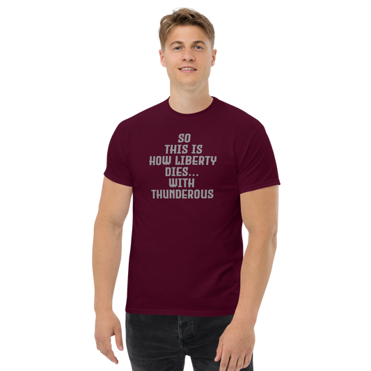 "So this is how liberty dies… with thunderous applause" printed on a maroon unisex classic tee worn by a male