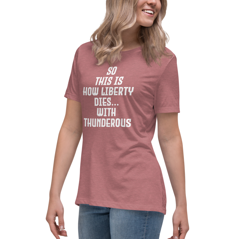 "So this is how liberty dies… with thunderous applause" printed on a heather mauve women's relaxed t-shirt worn by a female