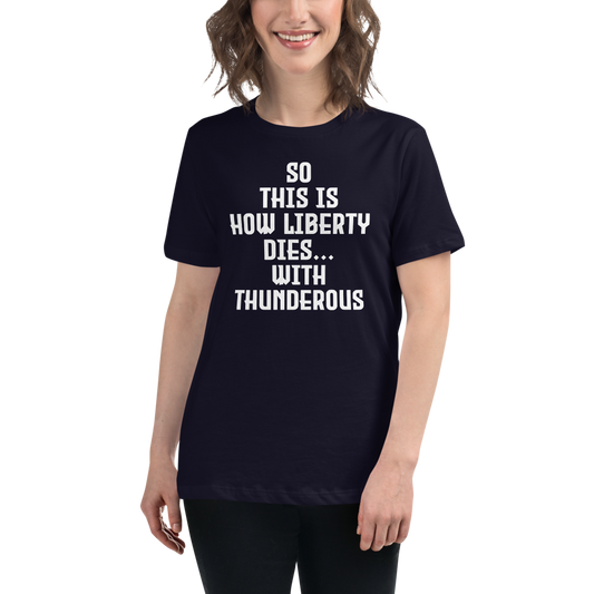"So this is how liberty dies… with thunderous applause" printed on a navy women's relaxed t-shirt worn by a female