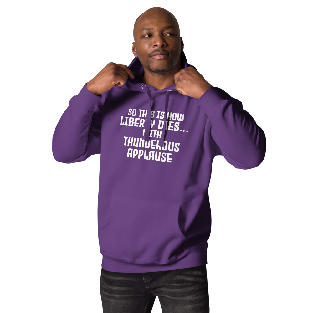 "So this is how liberty dies… with thunderous applause" printed on a purple unisex hoodie worn by a male